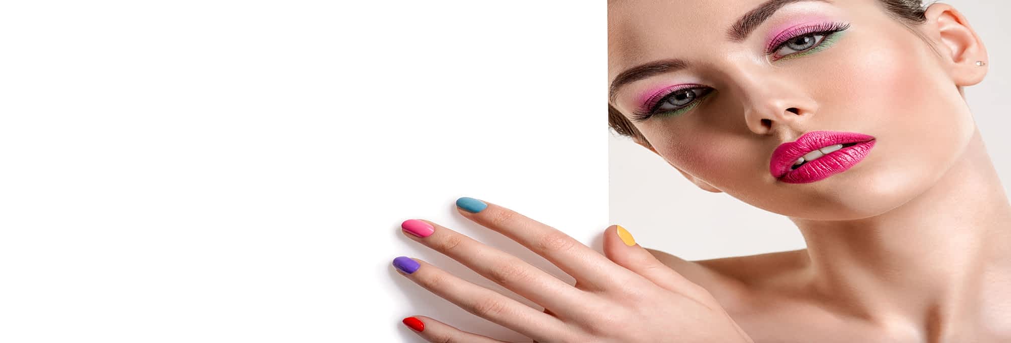 Beautiful woman with a colored manicure holds blank poster.